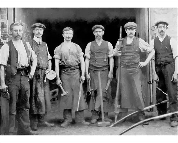 Blacksmiths outside their forge