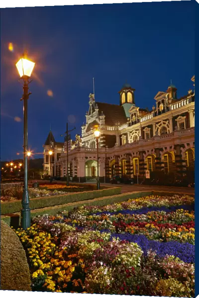 Flower garden and historic Railway Station at night, Dunedin, South Island, New Zealand