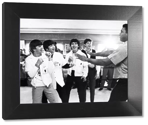 The Beatles (from left: Ringo Starr, John Lennon, George Harrison, and Paul McCartney) clowning with boxer Cassius Clay (later Muhammad Ali) at his training camp in Miami Beach, Florida, 18 February 1964, one week prior to his heavyweight championship fight with Sonny Liston