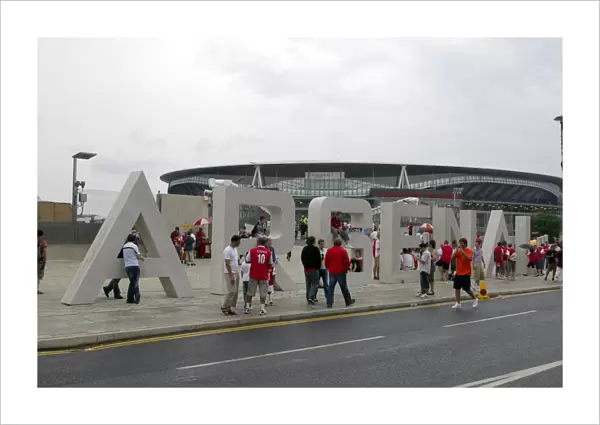 Arsenal fans gather outside the Emirates Stadium on thegiant letters near the south bridge
