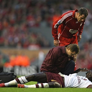 Injured Emmanuel Adebayor is treated by Arsenal physio Gary Lewin