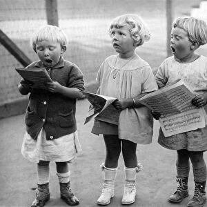 Four Young Children Singing