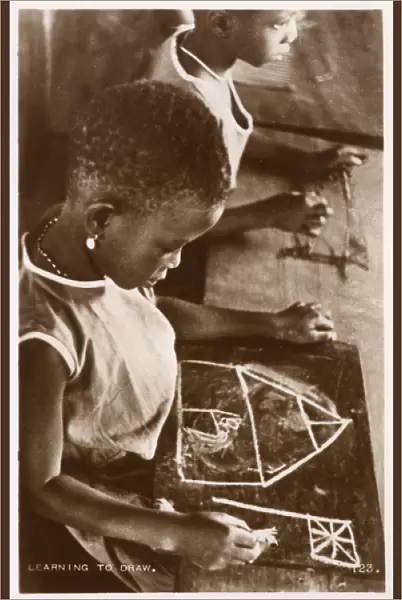 Young Ghanaian girl learning to draw
