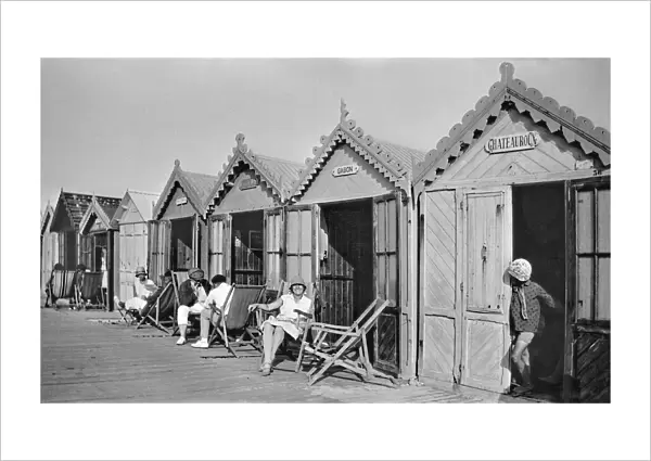 People outside beach huts, Cayeux, France
