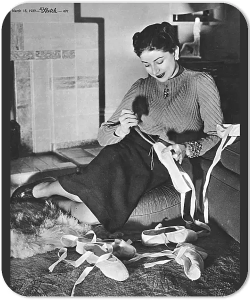 Margot Fonteyn repairing her ballet shoes