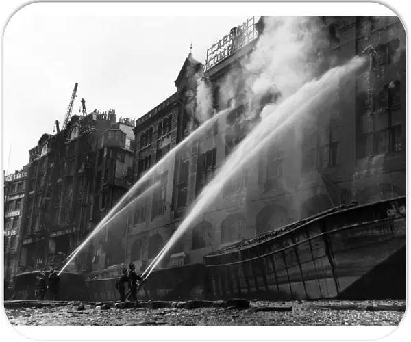 London firefighters at work with hosepipes