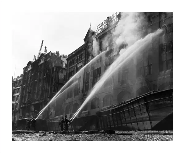 London firefighters at work with hosepipes