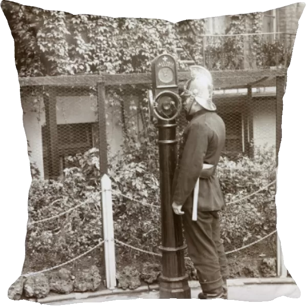 Firefighter using telephone point in street