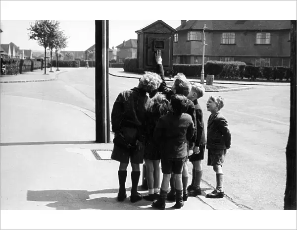 Street telephone fire alarm with group of children