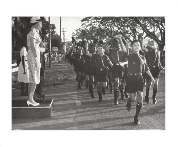 Cub scouts running past VIPs, British Guyana, South America