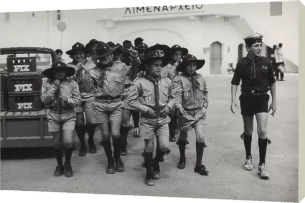 Boy scouts and a sea scout at a port, Greece