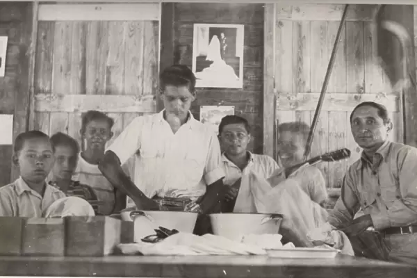 Boy scouts washing cutlery at camp, British Honduras