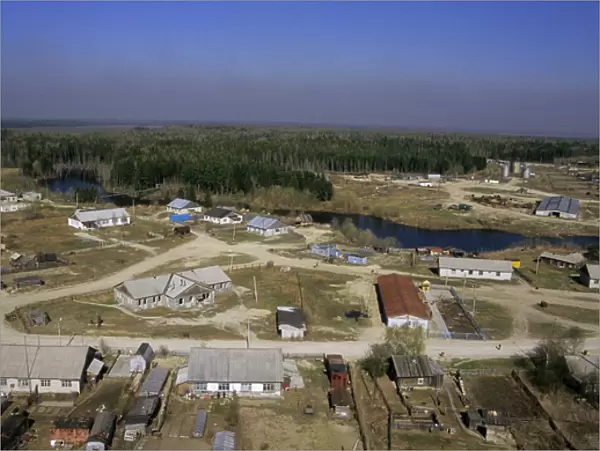 Maloyuganskii village - aerial of village and taiga forest