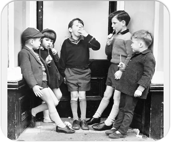 Children with ice lollies on a Balham street, SW London