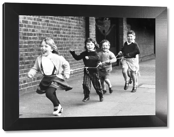 Children running with string, Balham, SW London