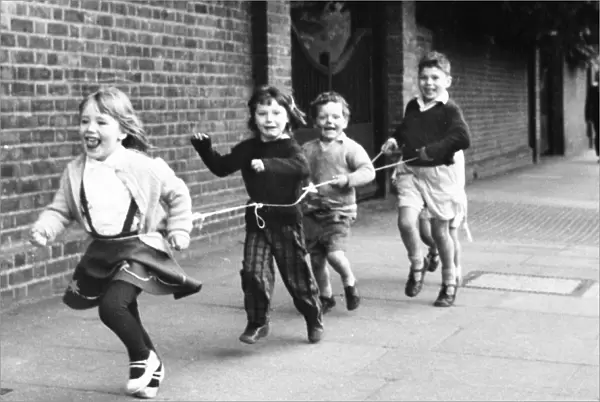 Children running with string, Balham, SW London