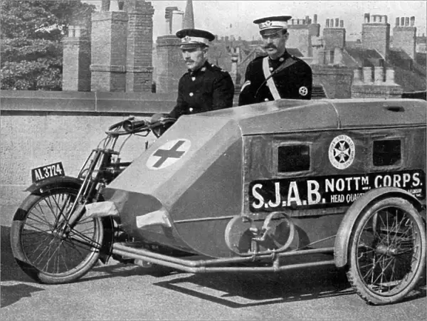 A Red Cross Ambulance with motor-cycle attached