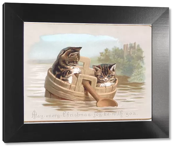 Two kittens in improvised boat on a Christmas card