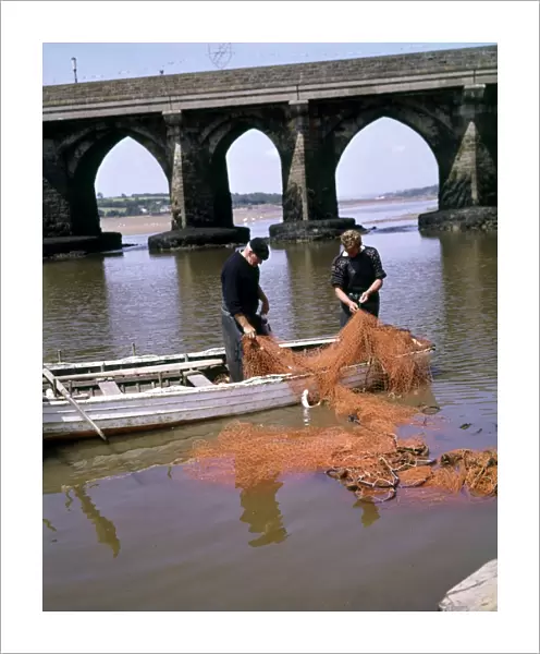 Two men repairing fishing nets, Bideford, Devon