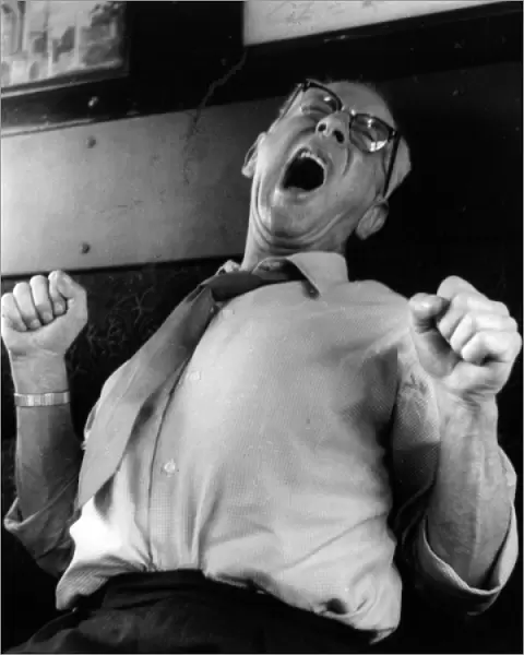 Man yawning and stretching on a train