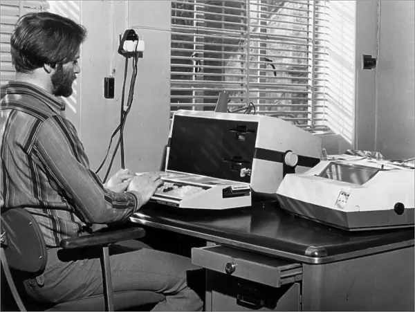 Man in an office with an Exidy Sorcerer computer