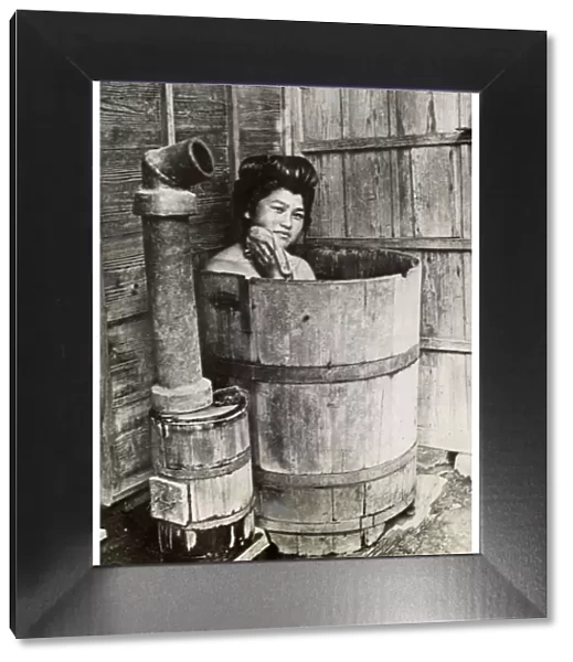 Traditional Japanese bathing in upright wooden tub