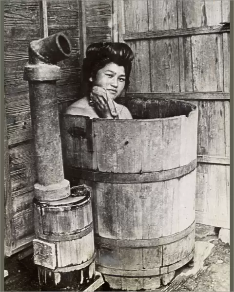 Traditional Japanese bathing in upright wooden tub