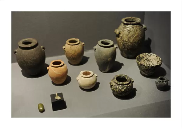 Stone jars and bowls with a small spoon and a small grinding