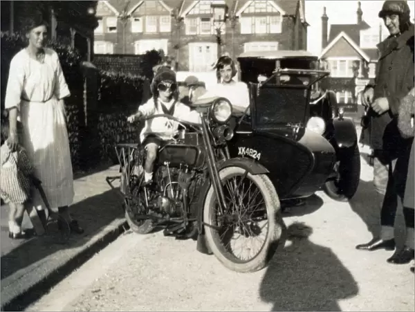 Boy sitting on a 1918 Harley Davidson motorcycle