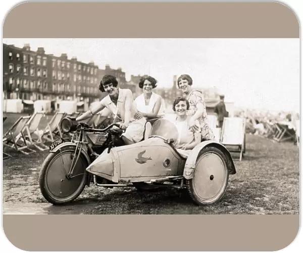Four Ladies sitting on a 1920 New Gerrard motorcycle & sidec