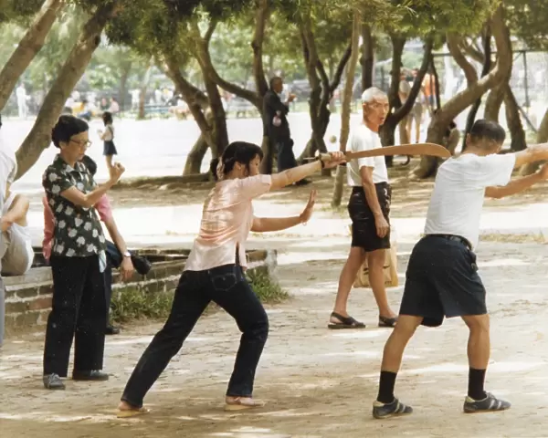 Man and woman shadow boxing in the park in Hong Kong