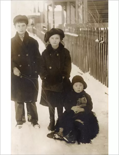Three children in the snow, USA