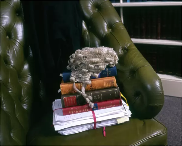 Lawyers books, brief and wig in a leather chair