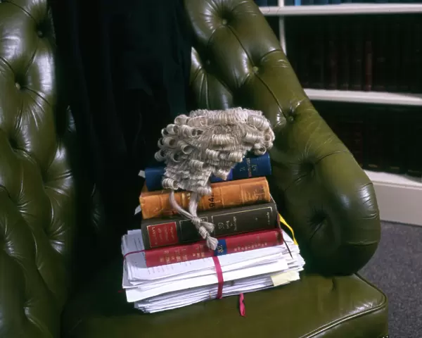 Lawyers books, brief and wig in a leather chair