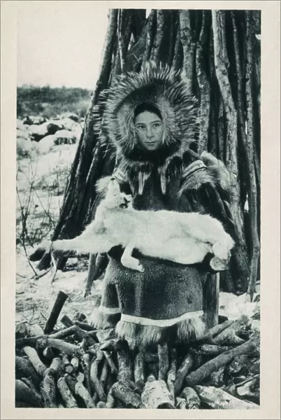 Young Eskimo (Inuit) girl with a captured Arctic Hare