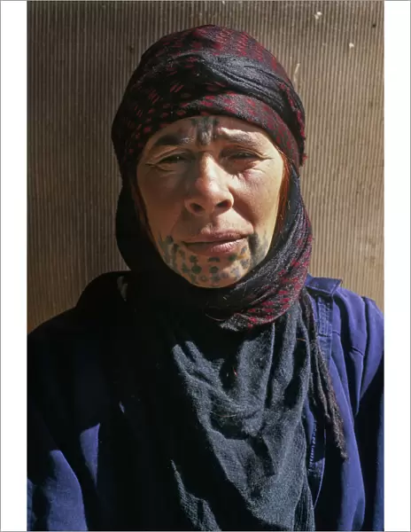 Bedouin woman with face tattoos outside her tent, Syria