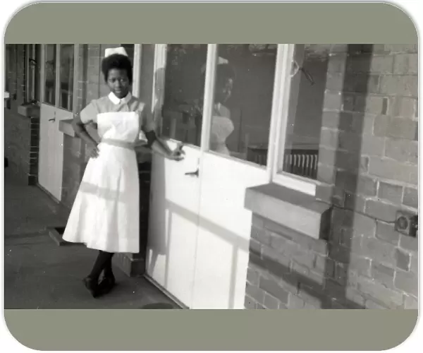 Nottingham. Student, Esmel May Woma in her nurses uniform leaning against the hospital