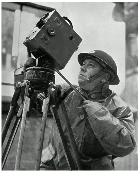 Cinematographer adjusts his camera, September 1939