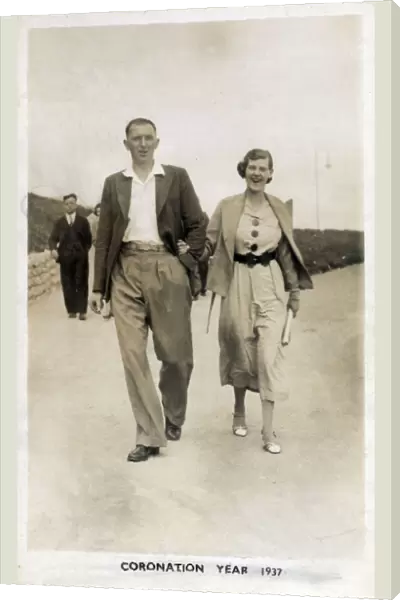 Young couple strolling along the seafront at Bridlington