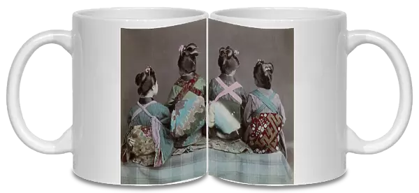 Back view of three geishas displaying obi sashes
