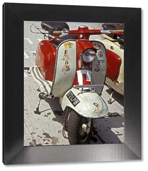 Red and white Lambretta with stickers