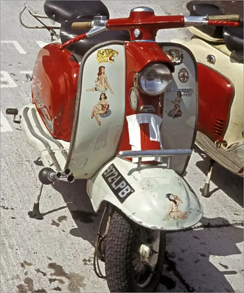 Red and white Lambretta with stickers