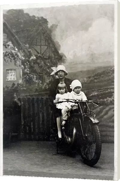 Mother and her two young children - studio photo on bike