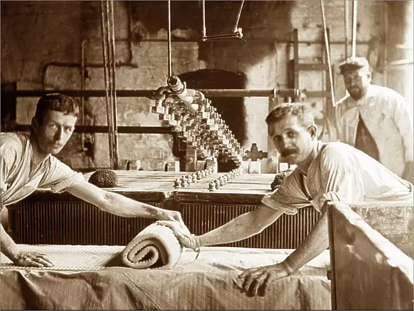 Blunging and pressing clay in a pottery factory