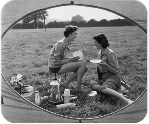 MEAL TIME. Two women enjoying a meal- whatever is in that box must be very tasty