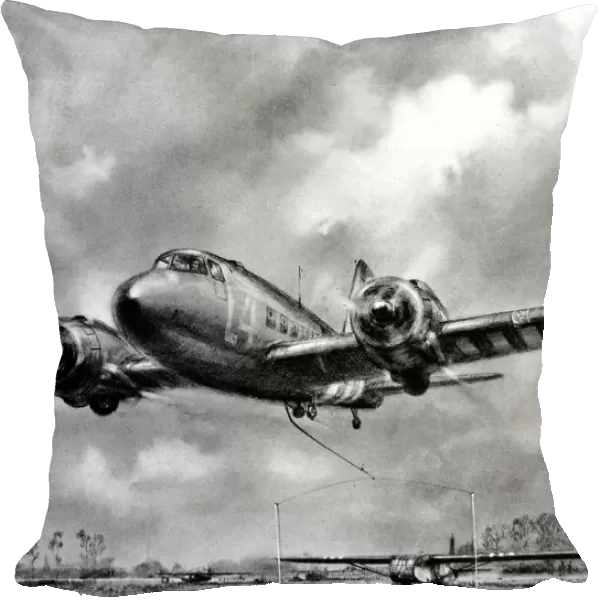 Douglas Dakota picking up a glider, Normandy; Second World W