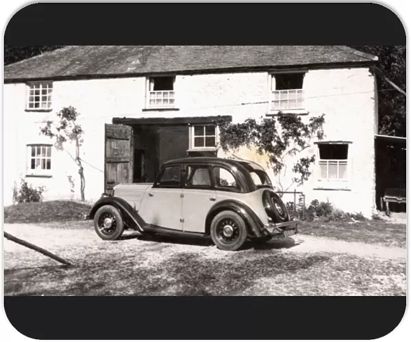 Morris 10  /  4 outside a country cottage