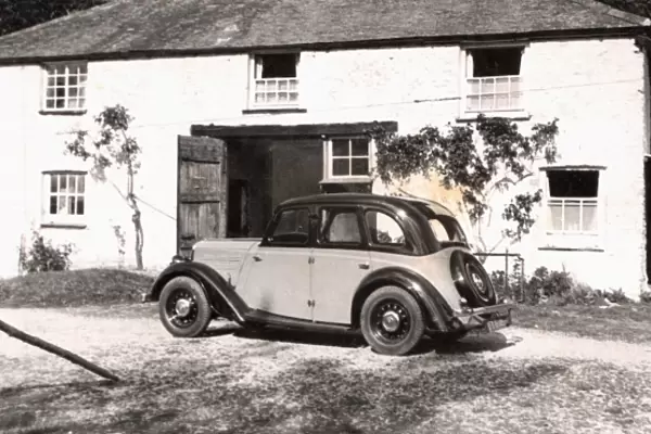 Morris 10  /  4 outside a country cottage
