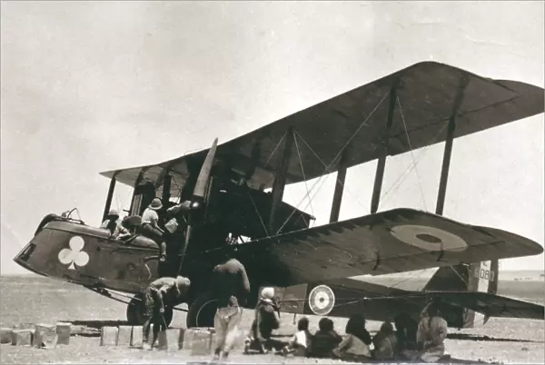 Biplane bomber with crew and arabs in the desert, Iraq