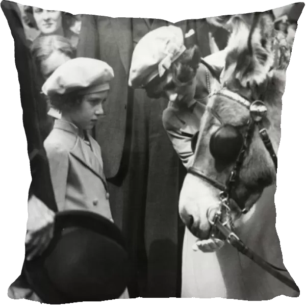 Queen Elizabeth II as a child with a donkey
